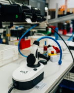 an-electric-vehicle-charger-sits-on-a-workbench-.jpg An electric vehicle charger sits on a workbench.
